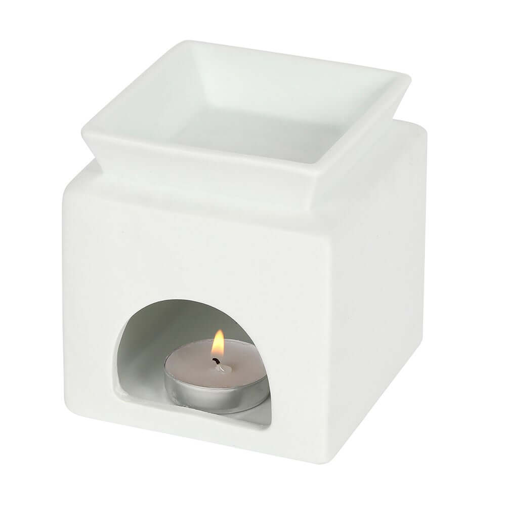 White ceramic wax melter with a heart cut-out, place a tealight inside, creating a cosy atmosphere.
