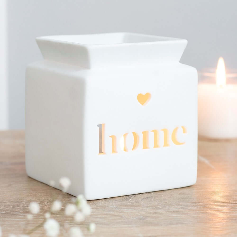 White ceramic wax melter with cut-out  'home' text for creating a cosy atmosphere.